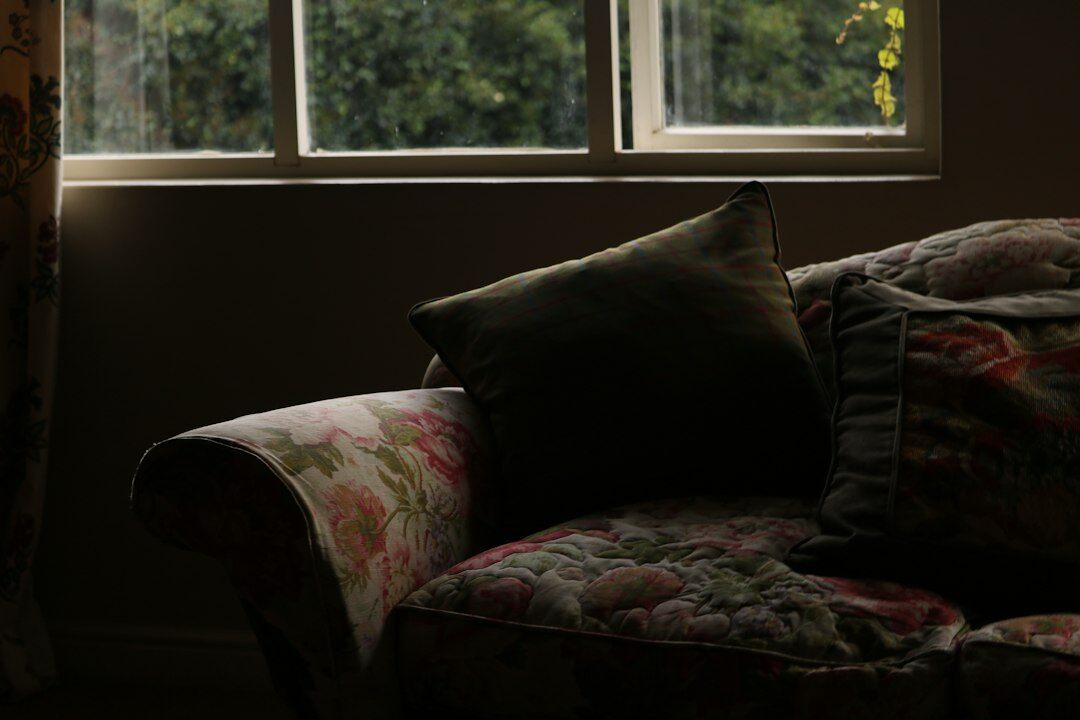 Old television glowing softly in a dark living room at night