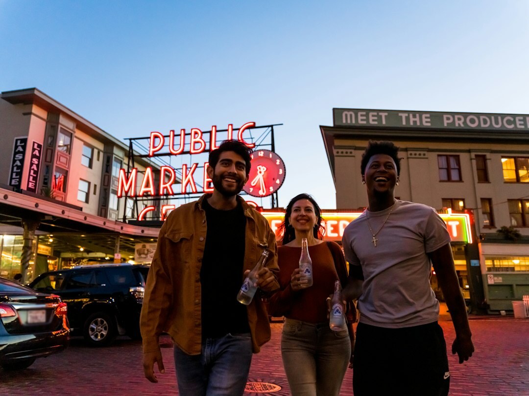 Diverse group of young people gathered together outside a venue at dusk